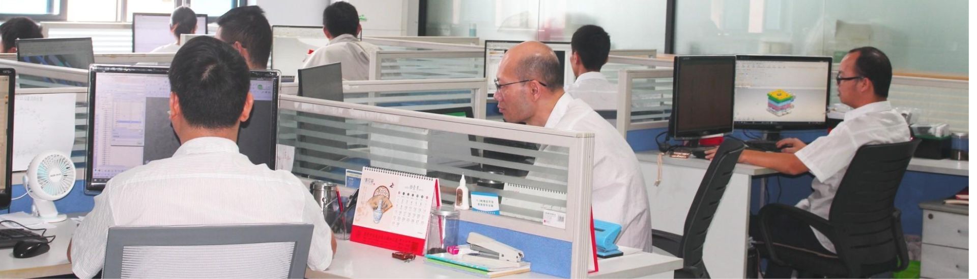 DTOP Mold engineering team working on 3D CAD mold designs in our Shenzhen office to optimize injection mold costs