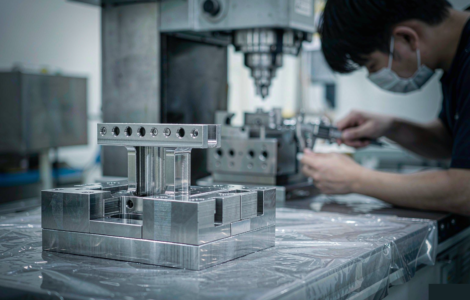 Precision steel injection mold on CNC workbench
